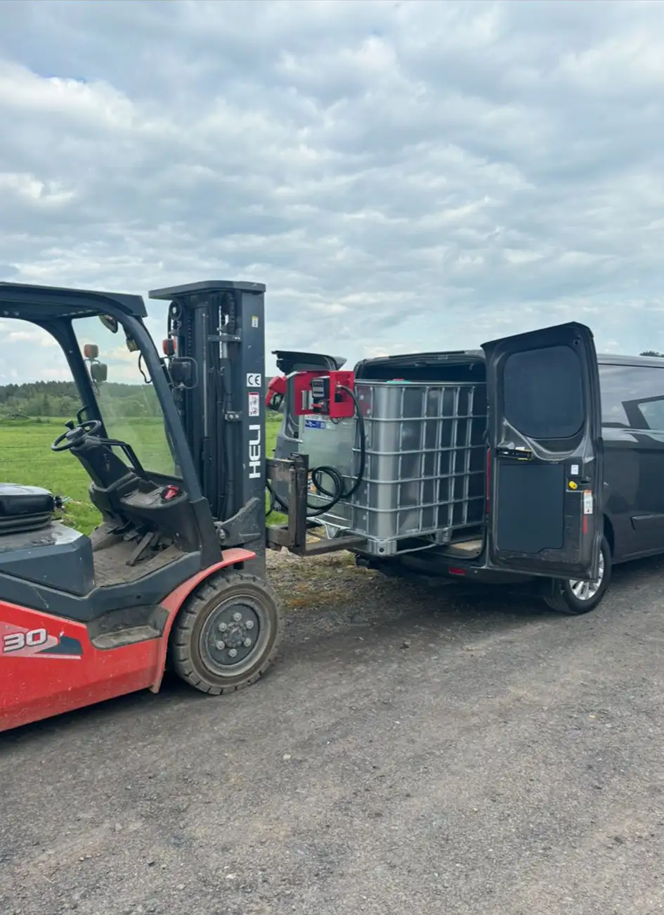  forklift placing fuel tank in van